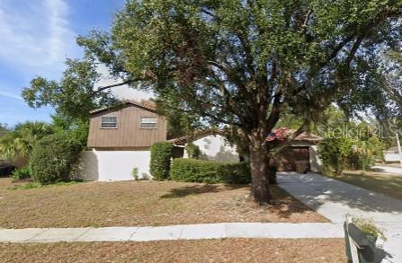 528 Lantern Circle Temple Terrace, FL 33617 - Photo 2 of 27 a front view of a house with a yard and garage