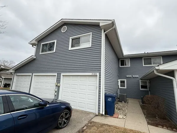 a side view of a house with parking space