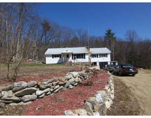 134 Wilker Road Ashburnham, MA 01430 - Photo 1 of 2 a view of a white house with a big yard and large trees
