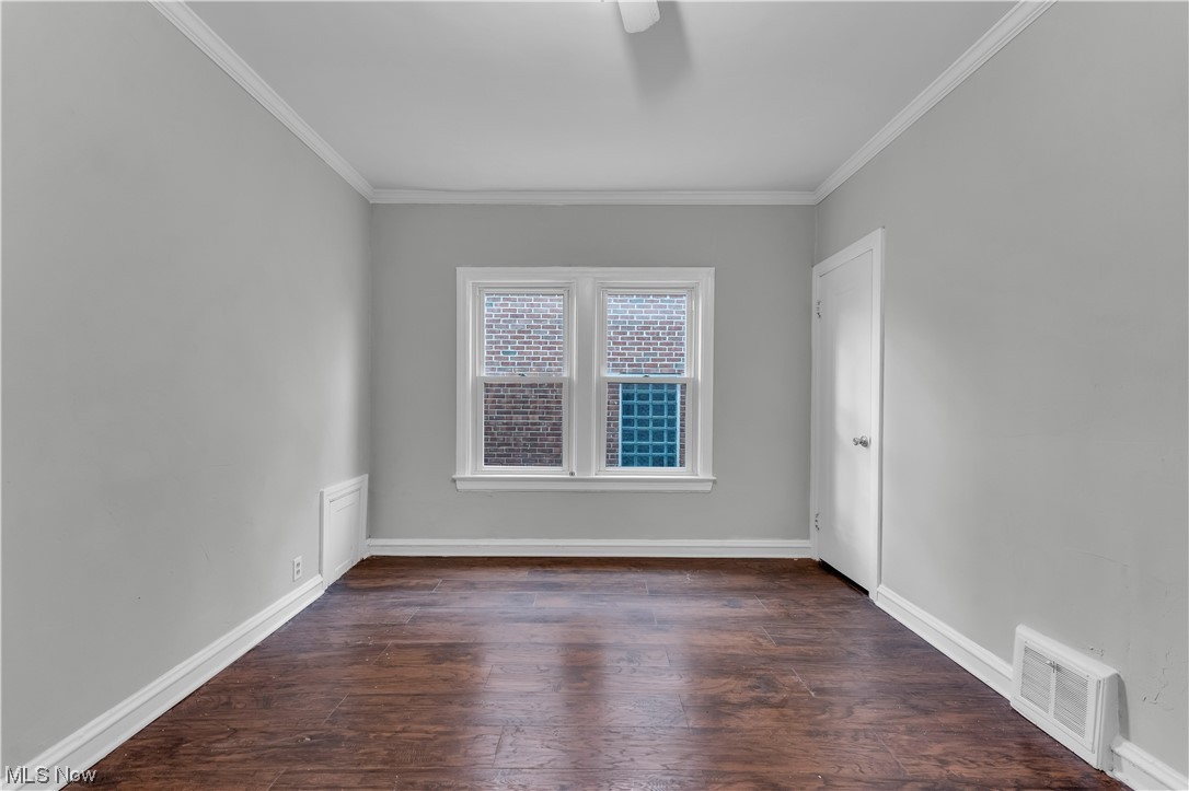 1499 Sherbrook Road South Euclid, OH 44121 - Photo 36 of 41 Unfurnished room featuring ornamental molding and dark wood-type flooring