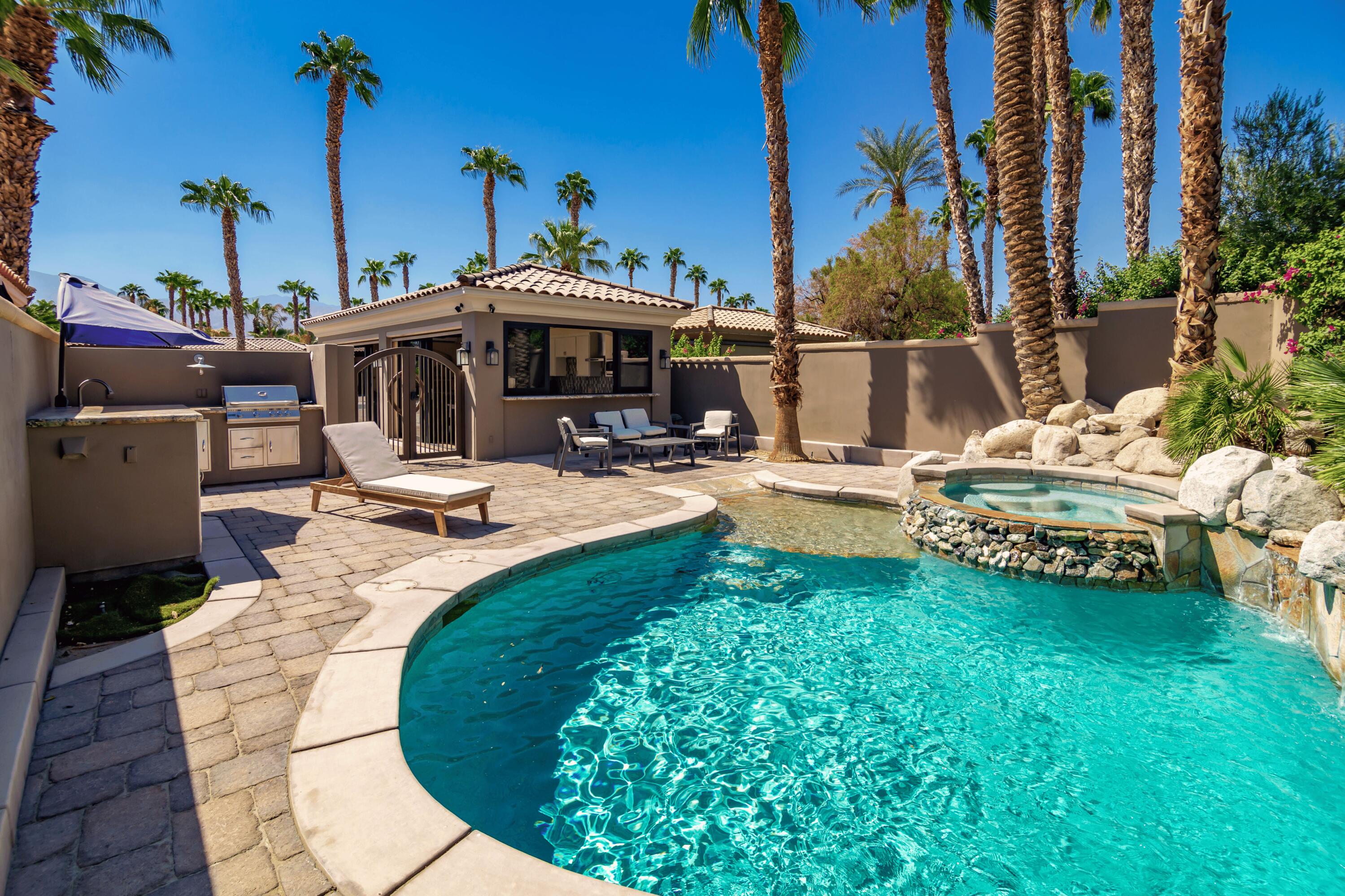 80501 Ave 48, Unit 21 Indio, CA 92201 - Photo 29 of 32 a view of a swimming pool with a lounge chairs