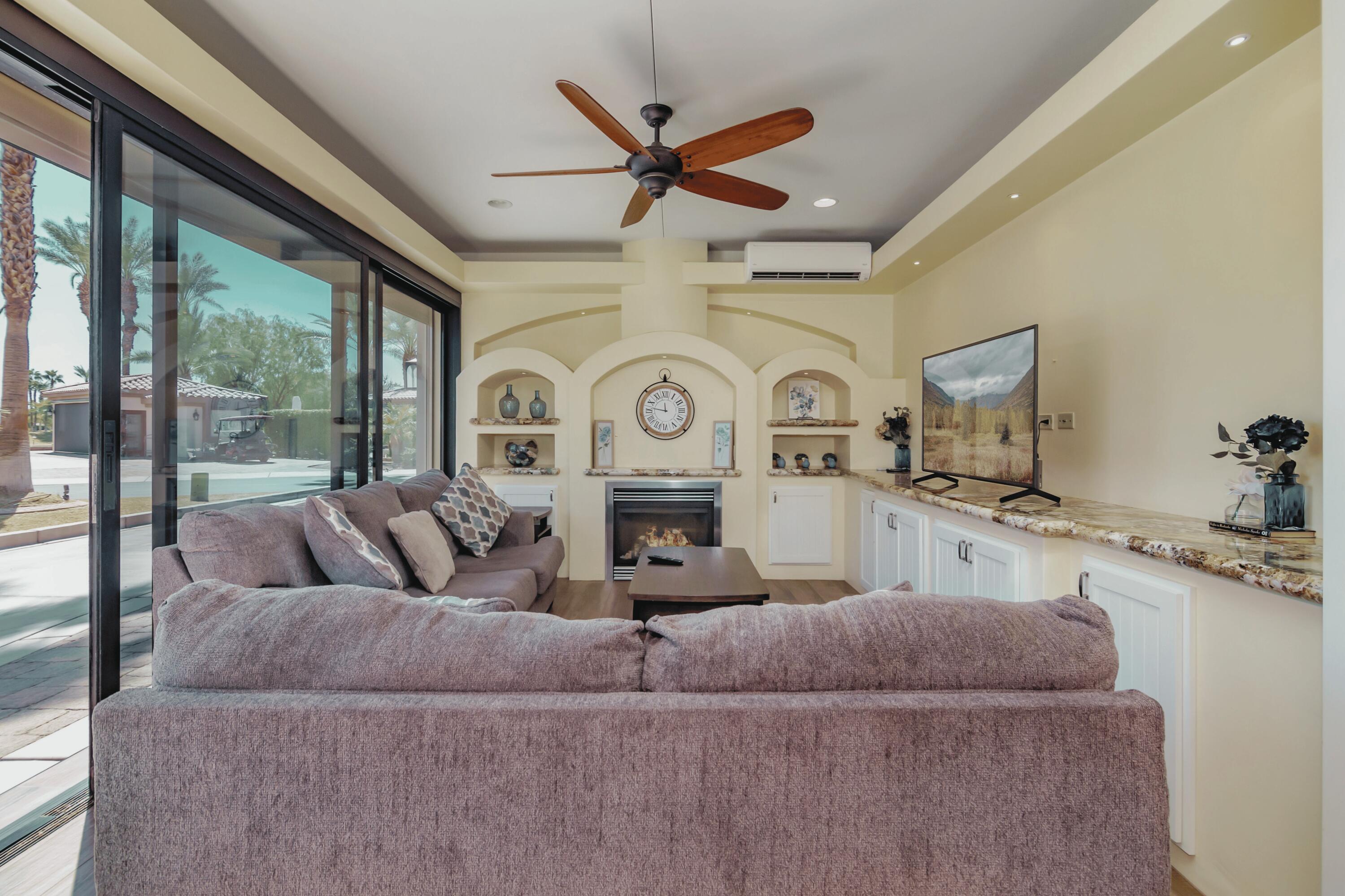 80501 Ave 48, Unit 21 Indio, CA 92201 - Photo 9 of 32 a living room with furniture a clock and a large window