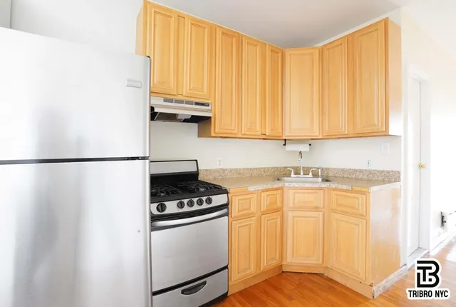 a kitchen with stainless steel appliances a stove a microwave and a refrigerator