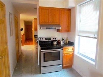10 Moreland Street, Unit 2 Boston, MA 02119 - Photo 2 of 15 a kitchen with a stove and a refrigerator