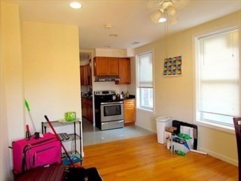 10 Moreland Street, Unit 2 Boston, MA 02119 - Photo 3 of 15 a living room with furniture and a kitchen view
