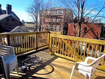 10 Moreland Street, Unit 2 Boston, MA 02119 - Photo 7 of 15 a view of a chairs on the deck