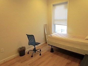 10 Moreland Street, Unit 2 Boston, MA 02119 - Photo 9 of 15 a bedroom with a bed chair and a window