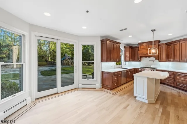 a large kitchen with stainless steel appliances granite countertop a stove and a sink
