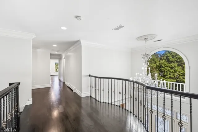 a view of a hallway with wooden floor and entryway