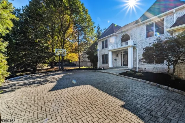 a view of a white house with a street