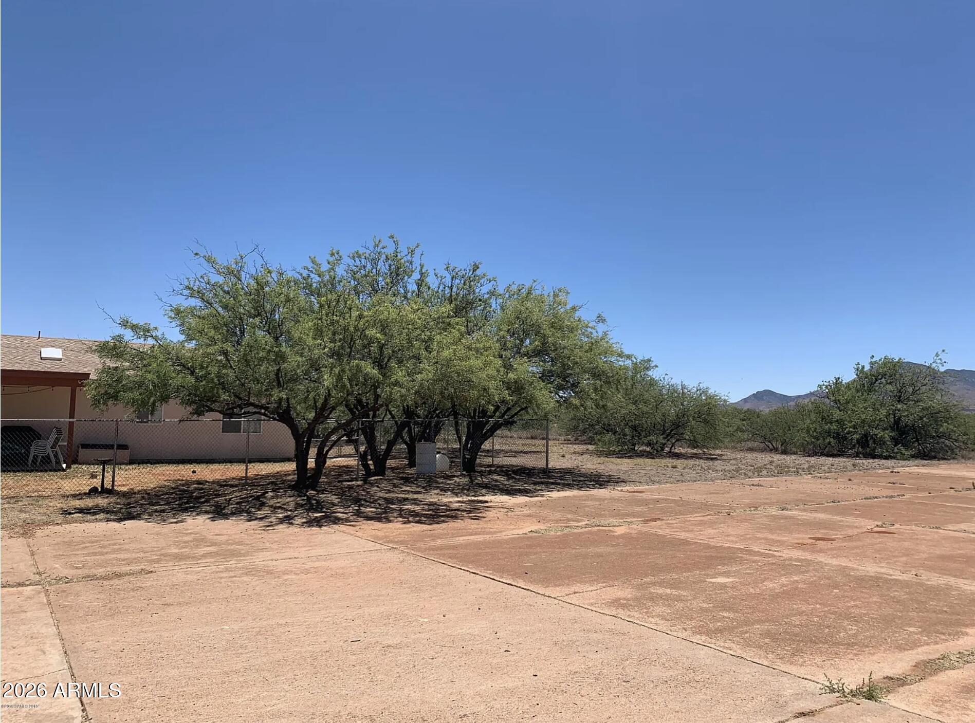 10193 East Windtalker Road Hereford, AZ 85615 - Photo 33 of 34 a backyard of a house with trees