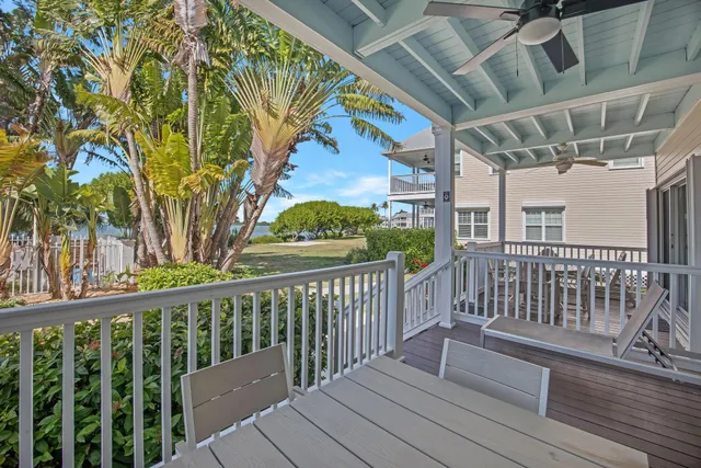 a view of a chairs and table in the balcony