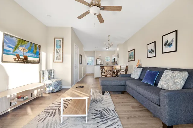 a living room with furniture and wooden floor