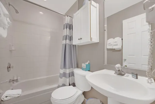 a bedroom with a bed and a night stand