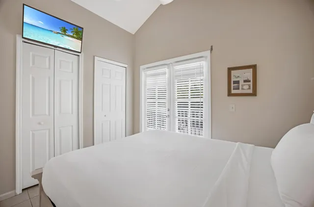 a bedroom with a bed and painting on the wall