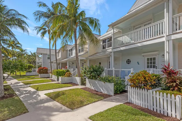 a view of a house with a yard and potted plants