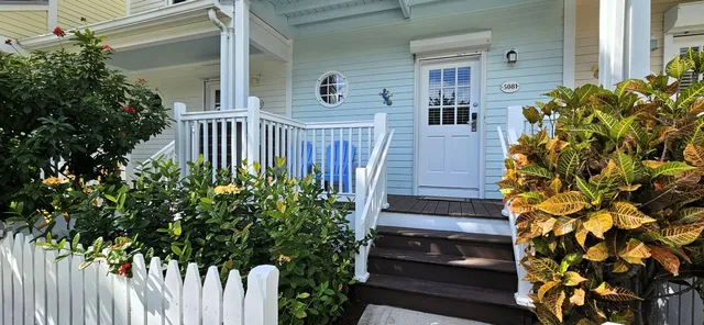 a view of stairs and garden with wooden fence