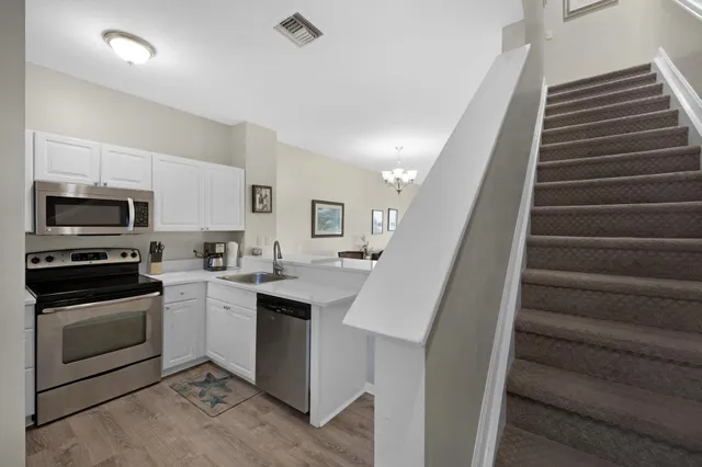 a kitchen with sink microwave and stove