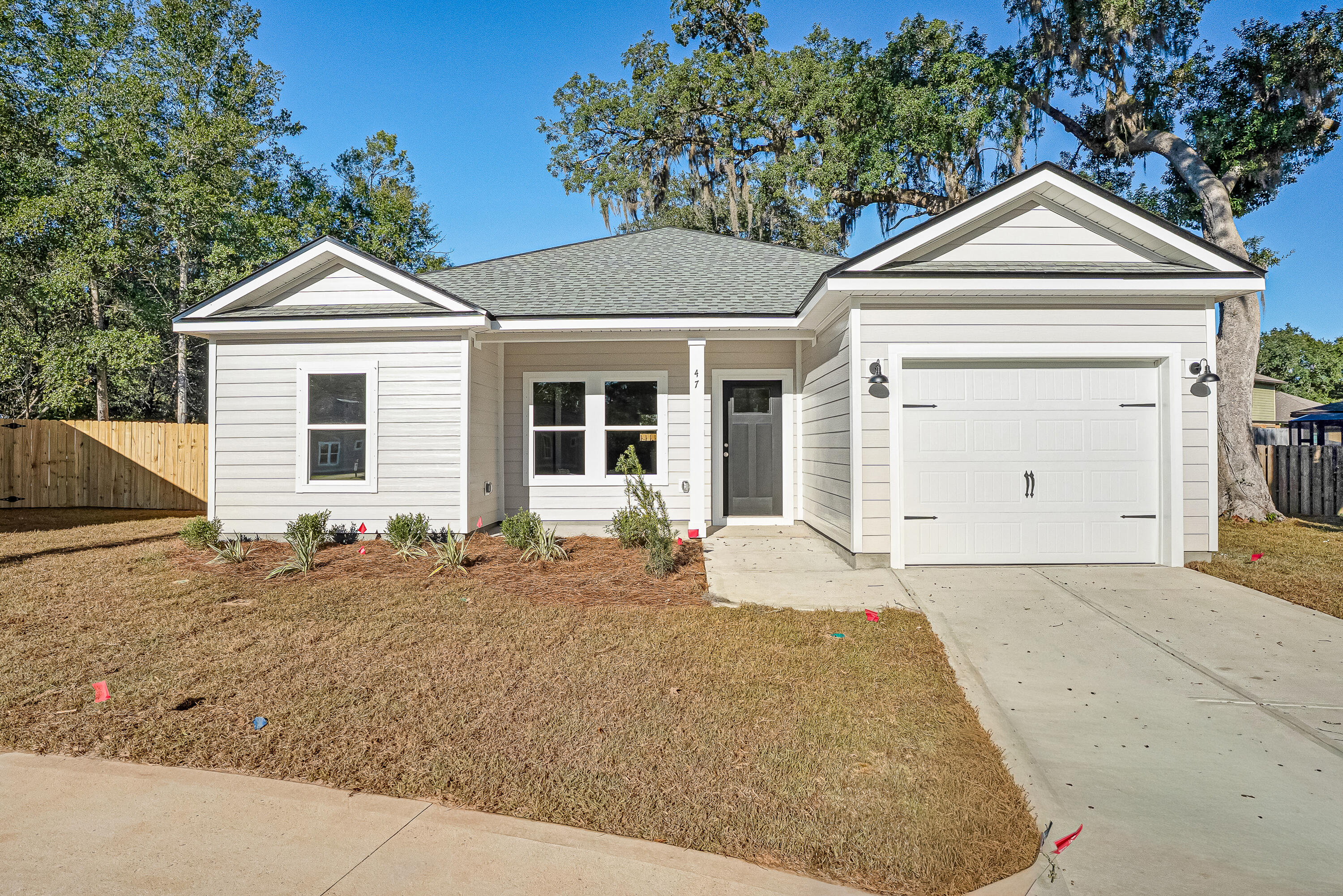 47 Shebbi Lane Freeport, FL 32439 - Photo 2 of 24 a front view of a house with a yard and garage