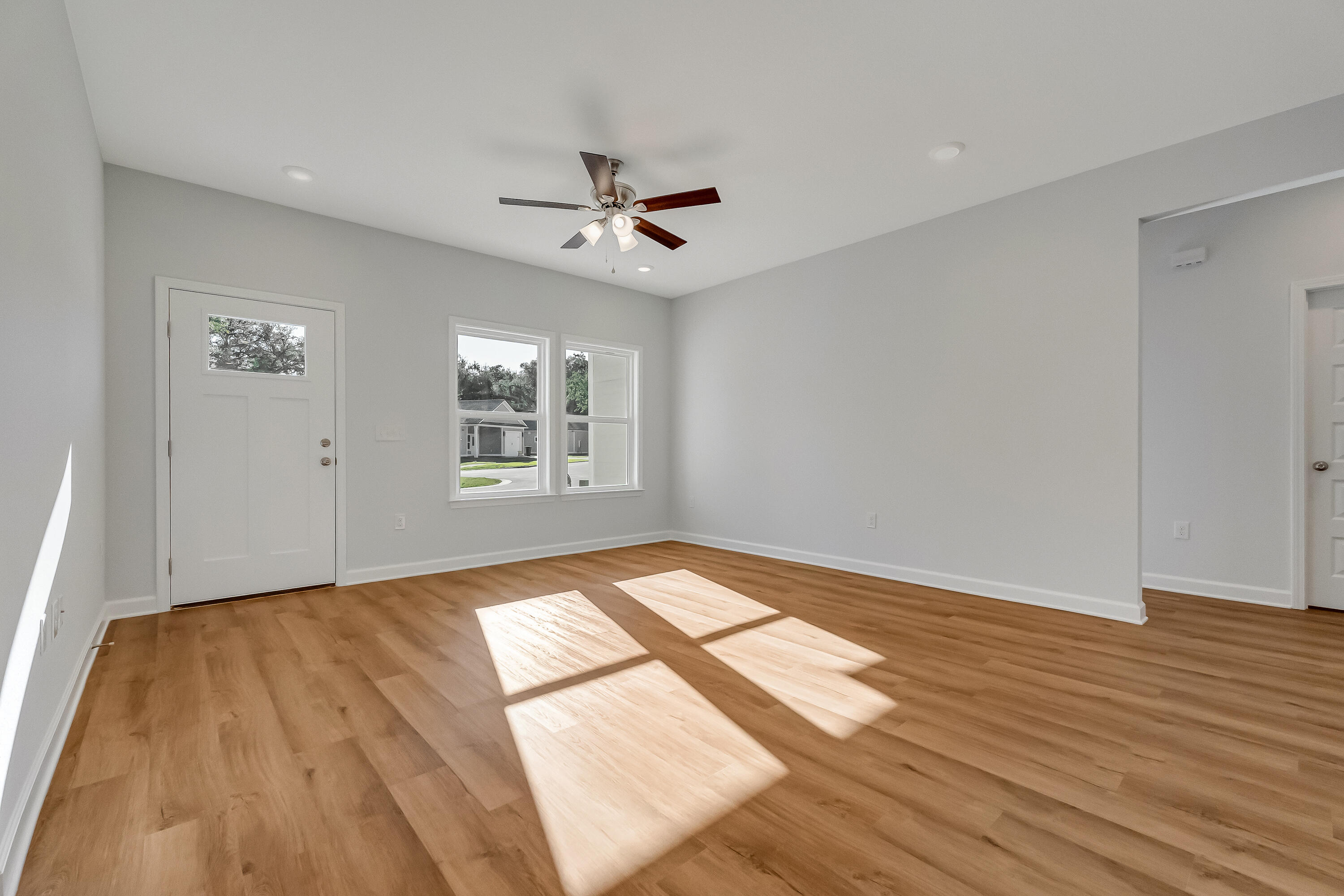 47 Shebbi Lane Freeport, FL 32439 - Photo 5 of 24 a view of empty room with wooden floor and fan