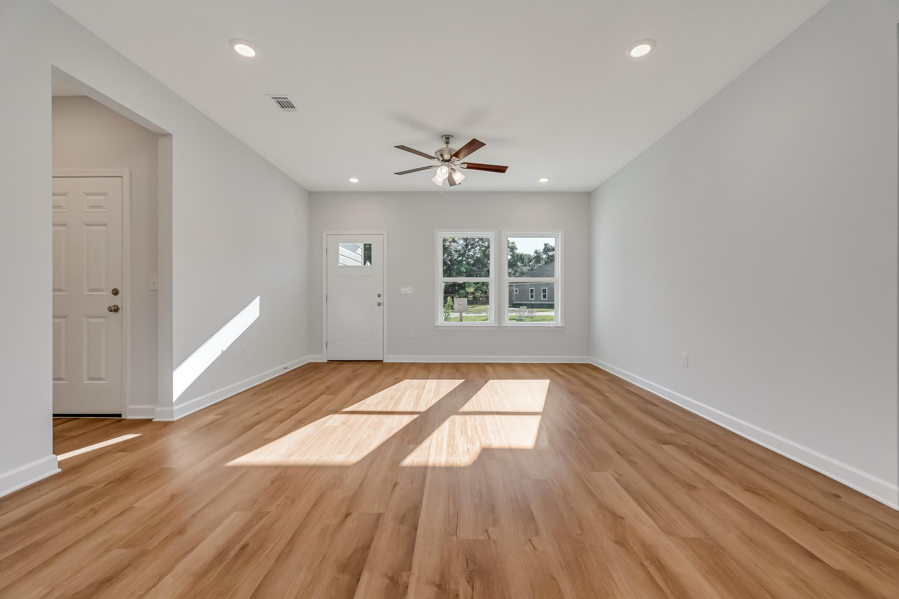 47 Shebbi Lane Freeport, FL 32439 - Photo 6 of 24 wooden floor in an empty room with a window