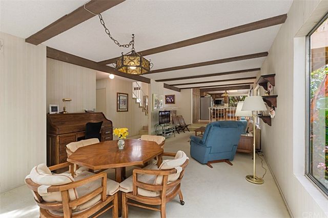 a kitchen with granite countertop a refrigerator and a stove top oven