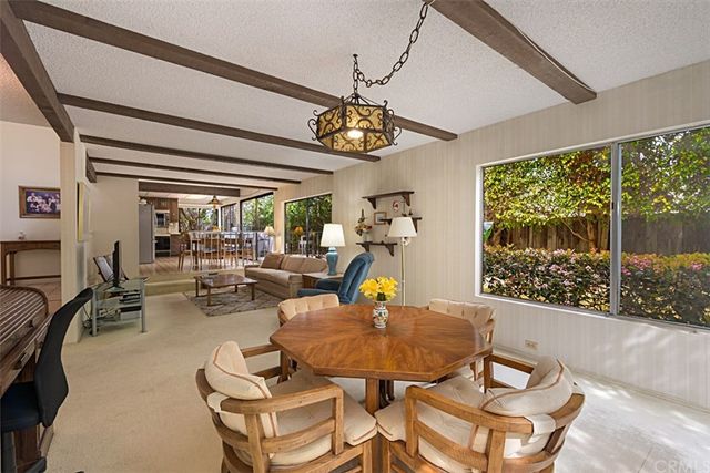 a kitchen with a sink and large windows