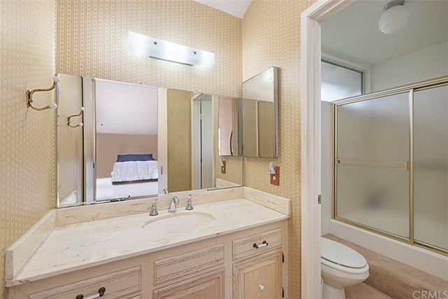 a bedroom with a bed and a lamp next to a window