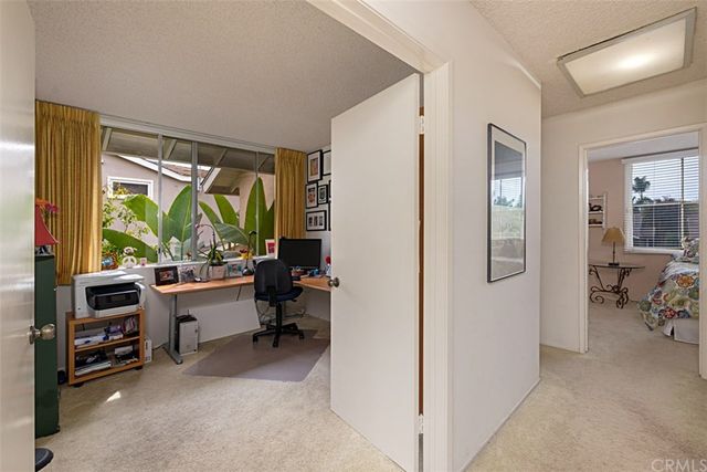 a bedroom with furniture and a large window