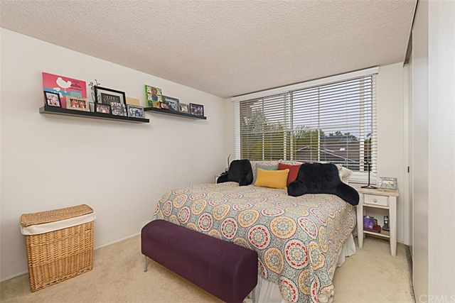 a view of a patio with a table and chairs under an umbrella