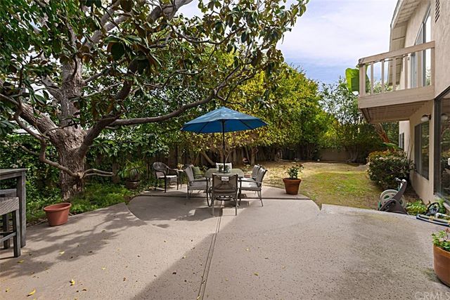 a backyard of a house with table and chairs