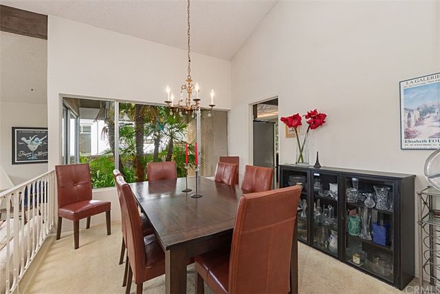 a dining room with furniture and a chandelier