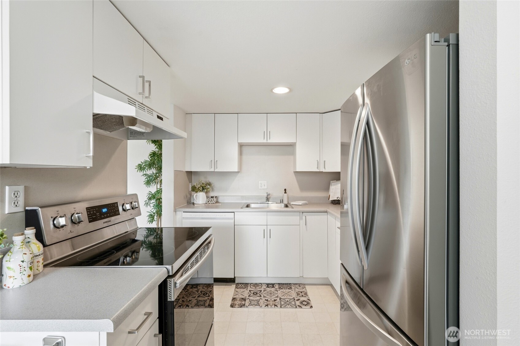 2531 South 248th Street, Unit A18 Kent, WA 98032 - Photo 12 of 28 a kitchen with stainless steel appliances granite countertop a refrigerator sink and stove