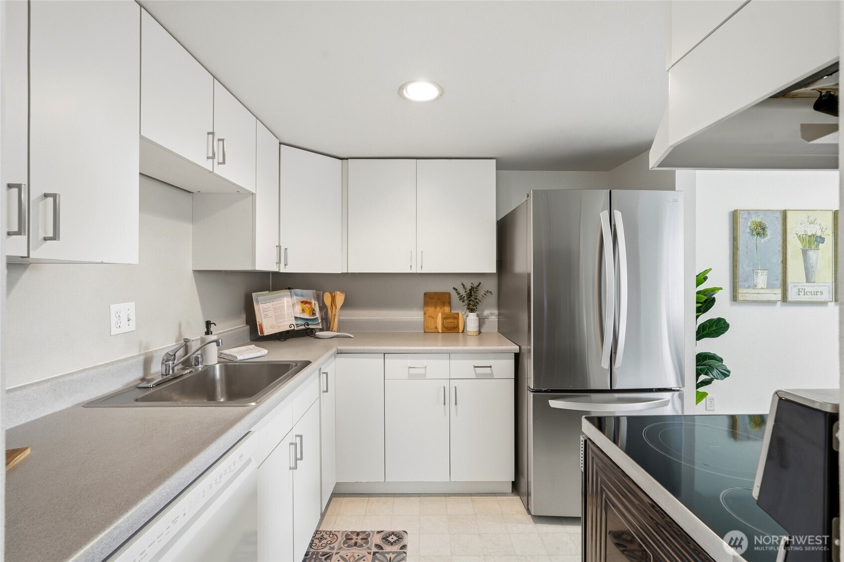 2531 South 248th Street, Unit A18 Kent, WA 98032 - Photo 15 of 28 a kitchen with stainless steel appliances a sink stove refrigerator and cabinets