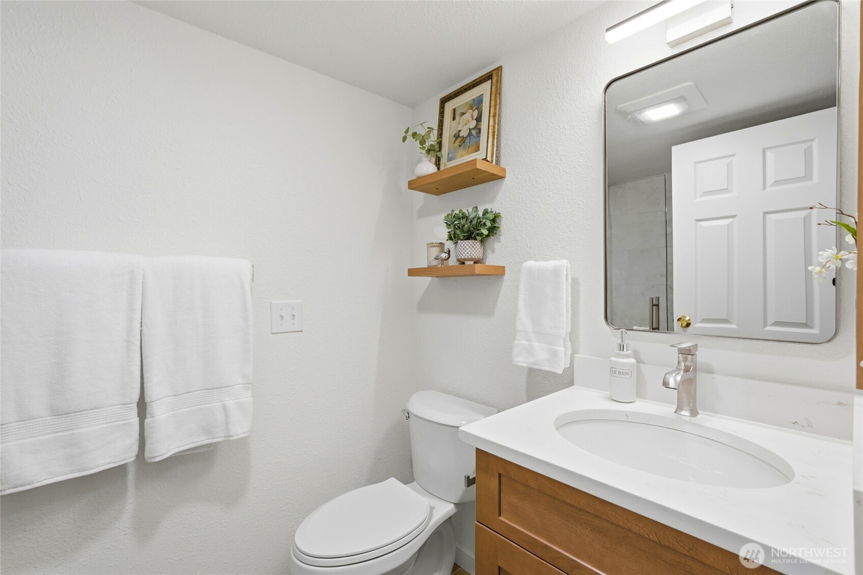 2531 South 248th Street, Unit A18 Kent, WA 98032 - Photo 16 of 28 a bathroom with a sink a toilet and mirror