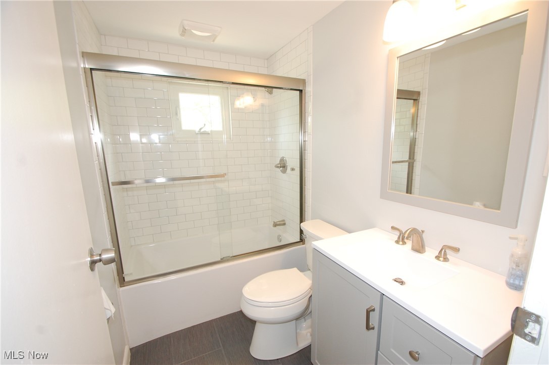 6284 Herbert Road Canfield, OH 44406 - Photo 20 of 24 Bathroom featuring toilet, vanity, and enclosed tub / shower combo