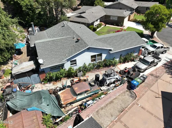 an aerial view of a house with a garden and mountain view
