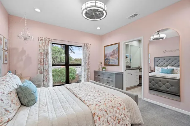 a bedroom with a large bed and a window