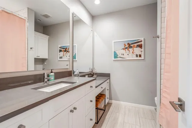 a bathroom with a granite countertop sink a mirror and a