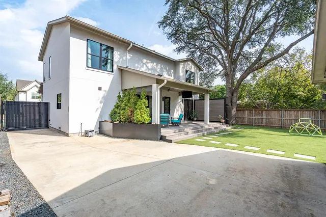 a view of a backyard with a garden and entertaining space