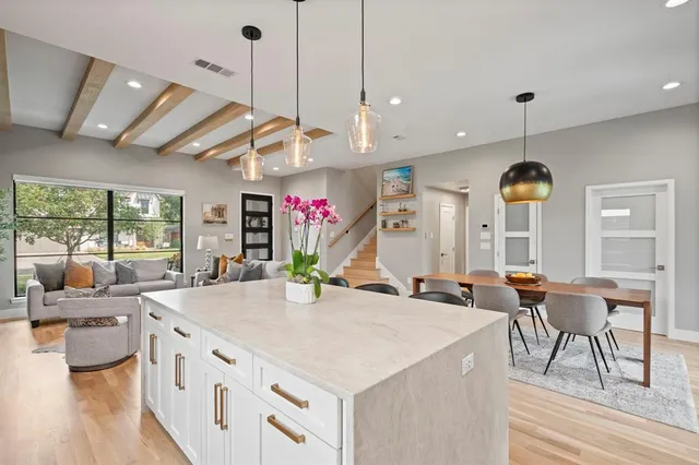 a kitchen with stainless steel appliances granite countertop a stove and a wooden floors