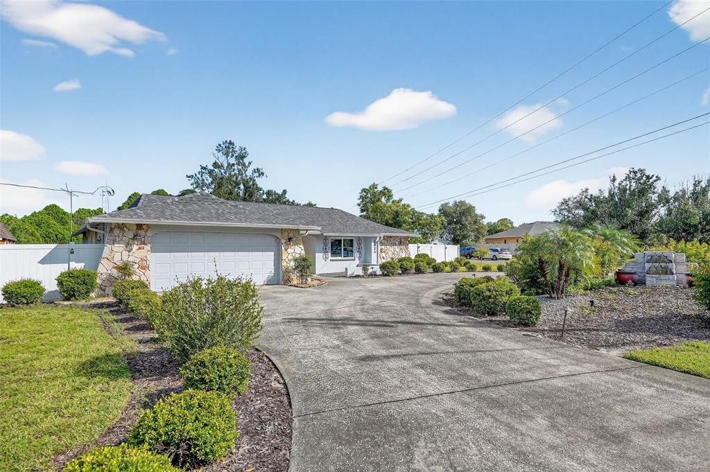 3025 Whitewood Avenue Spring Hill, FL 34609 - Photo 12 of 53 a front view of a house with a yard and potted plants