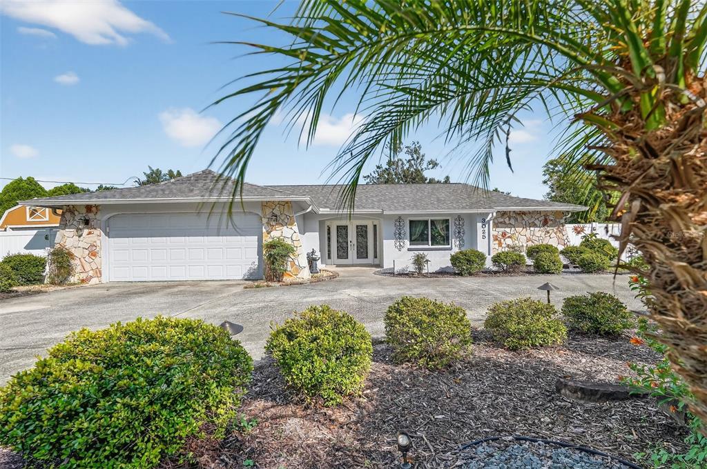 3025 Whitewood Avenue Spring Hill, FL 34609 - Photo 13 of 53 front view of a house with a garden