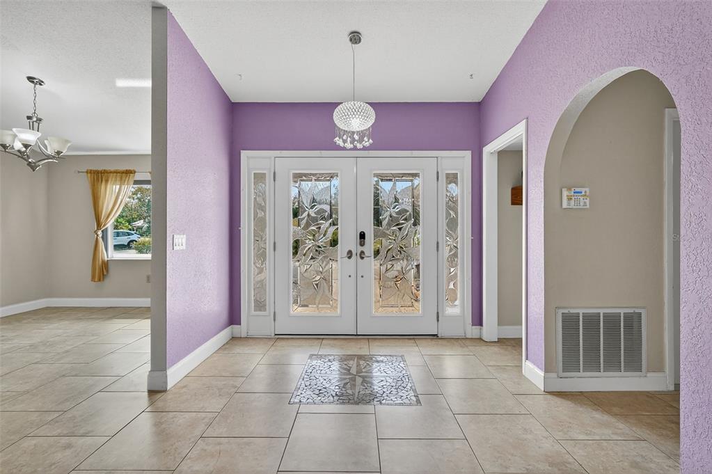 3025 Whitewood Avenue Spring Hill, FL 34609 - Photo 16 of 53 a view of an entryway with a chandelier