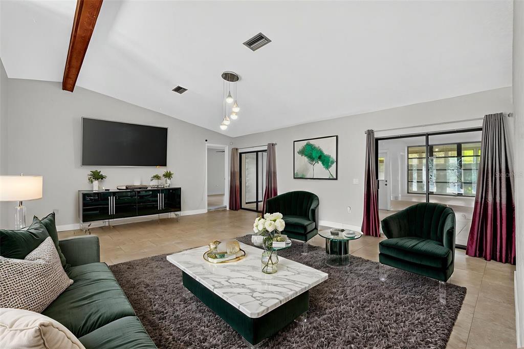 3025 Whitewood Avenue Spring Hill, FL 34609 - Photo 18 of 53 a living room with furniture and a flat screen tv