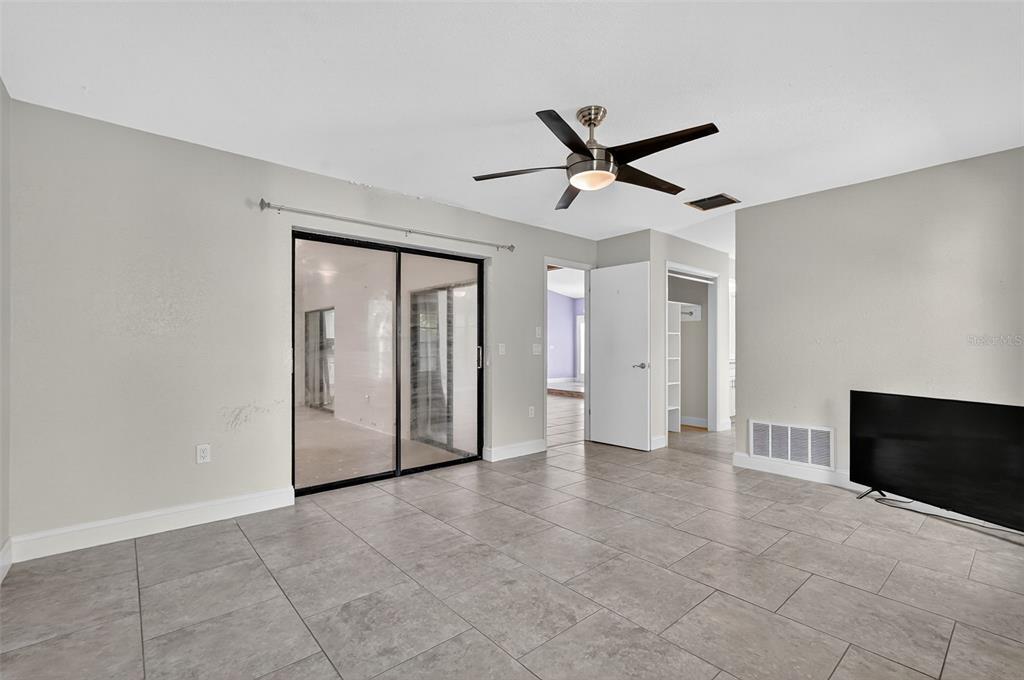 3025 Whitewood Avenue Spring Hill, FL 34609 - Photo 22 of 53 a view of a livingroom with a ceiling fan and window