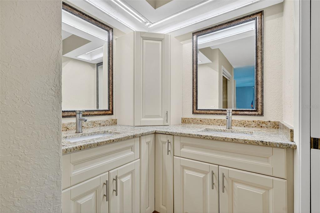 3025 Whitewood Avenue Spring Hill, FL 34609 - Photo 24 of 53 a bathroom with a granite countertop sink vanity and mirror
