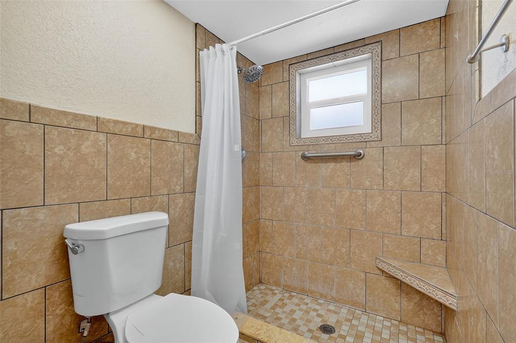 3025 Whitewood Avenue Spring Hill, FL 34609 - Photo 25 of 53 a white toilet sitting next to a bathroom sink