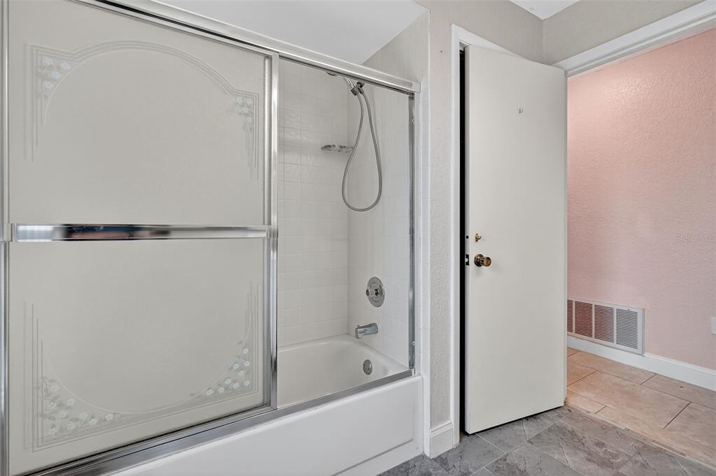 3025 Whitewood Avenue Spring Hill, FL 34609 - Photo 31 of 53 a bathroom with a shower and a bath tub