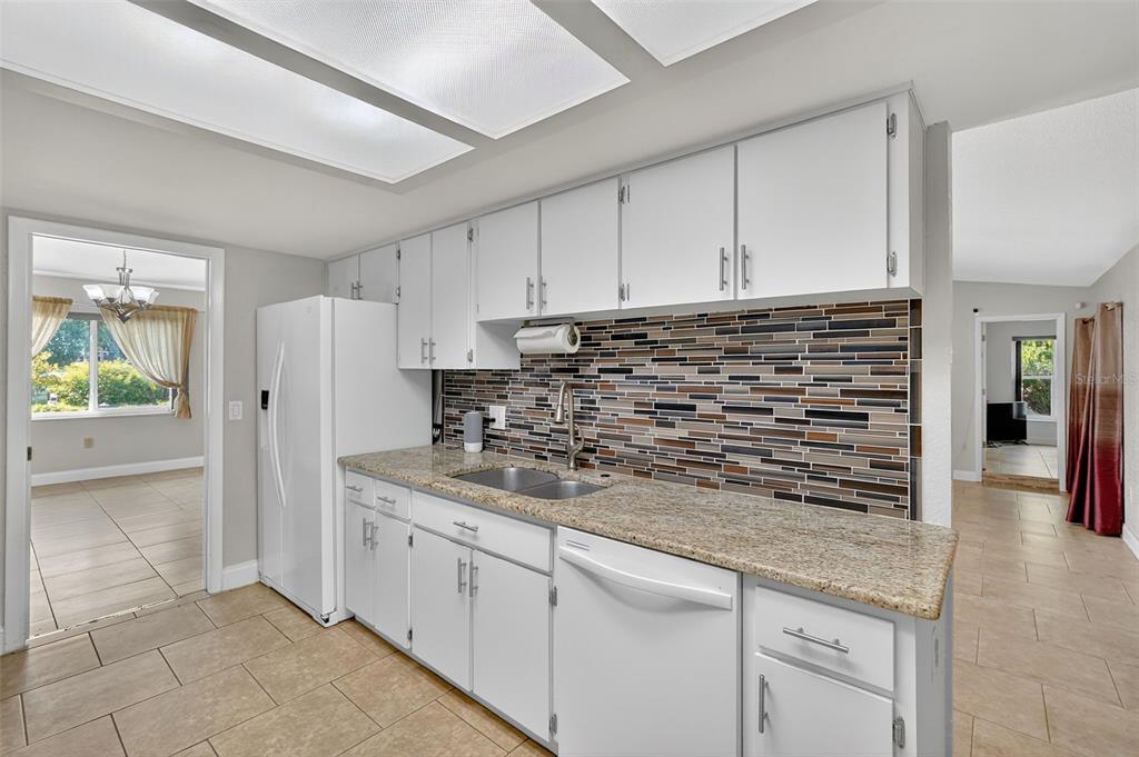 3025 Whitewood Avenue Spring Hill, FL 34609 - Photo 39 of 53 a kitchen with stainless steel appliances granite countertop a refrigerator and a sink